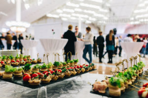 fancy catering food on a table at an indoor party